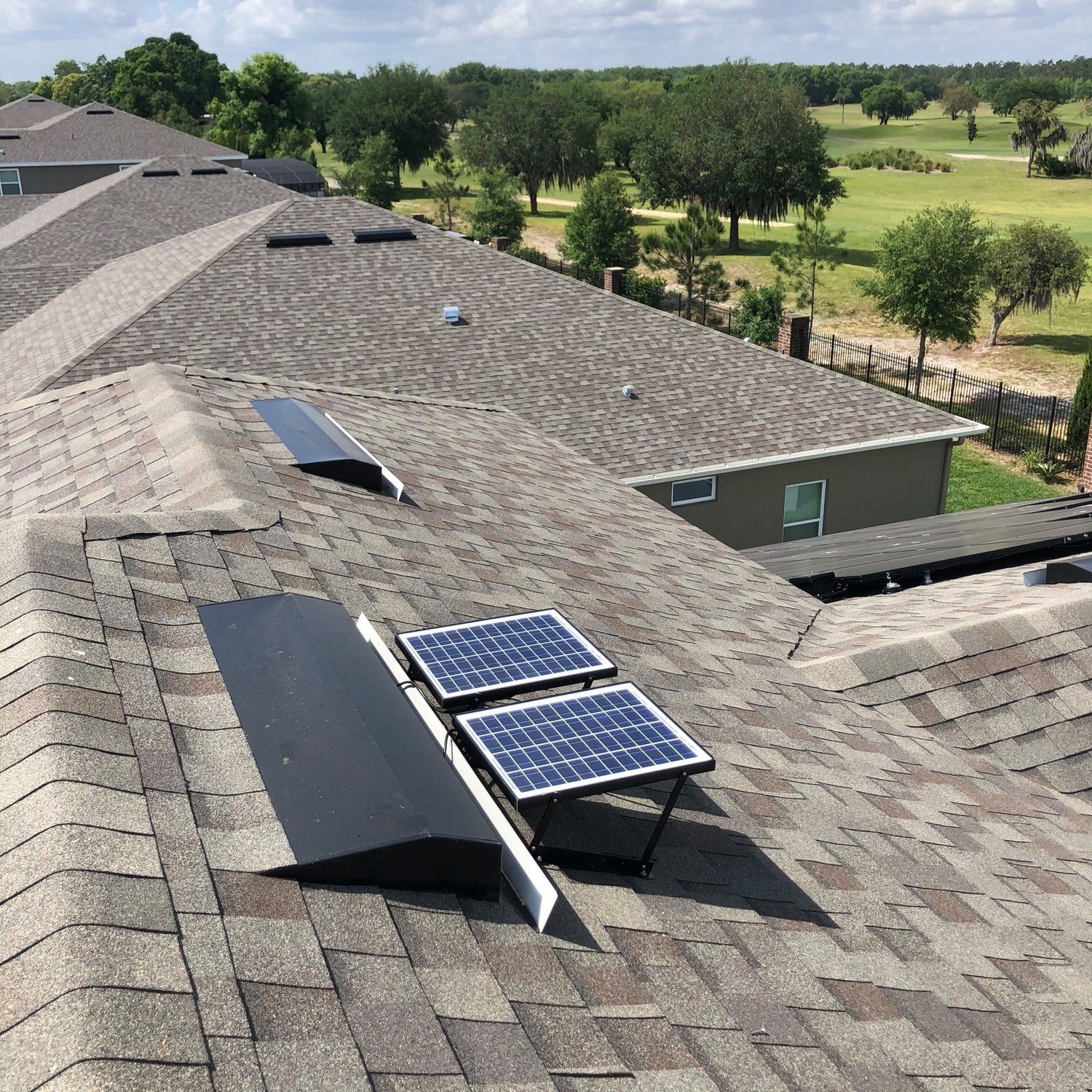Two solar attic fans mounted on a roof.